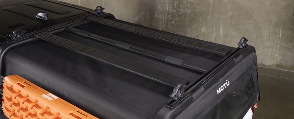 Truck cap with canvas canopy and rack showing molle panels to attach gear.